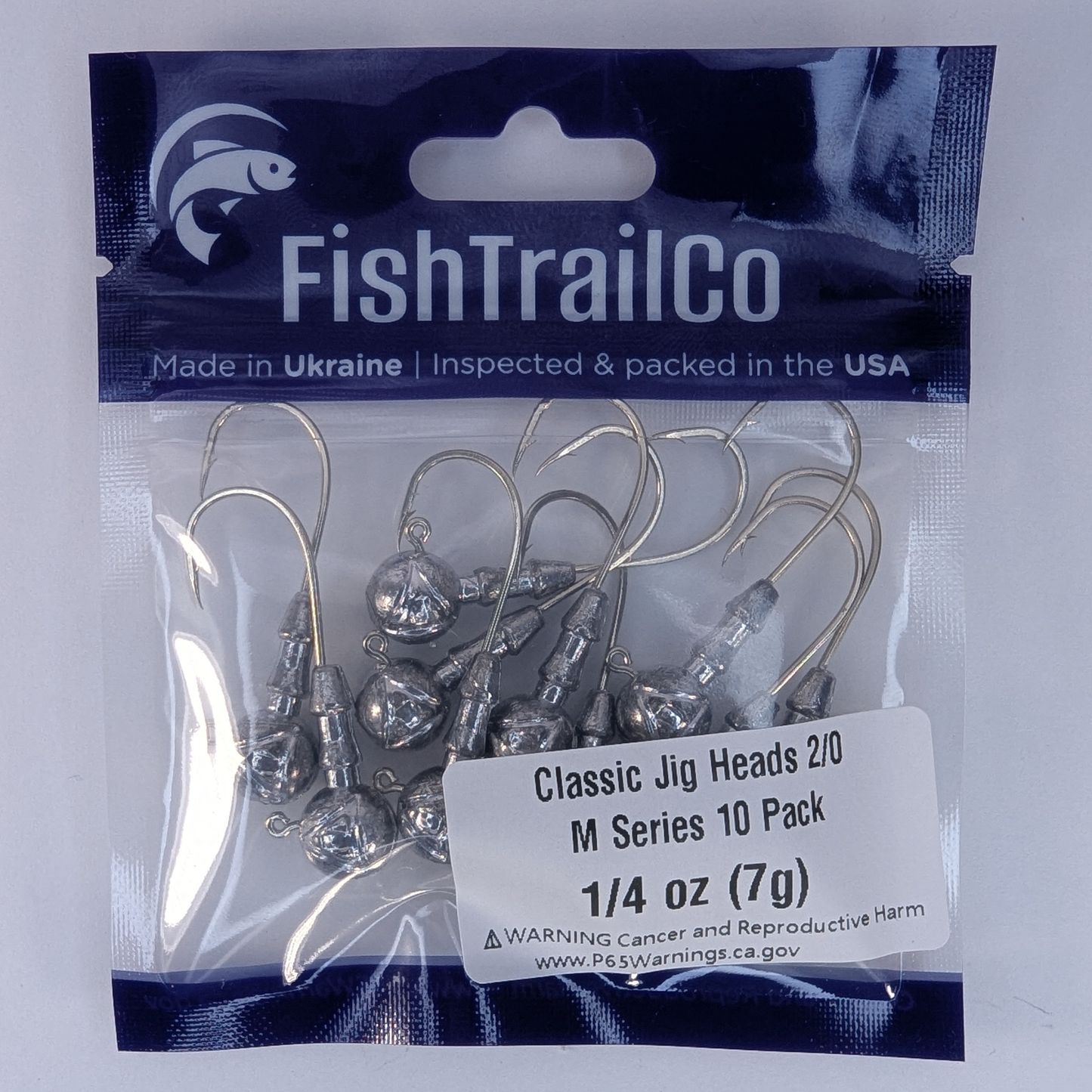 Packaged fishing hooks with FishTrailCo branding on a white background