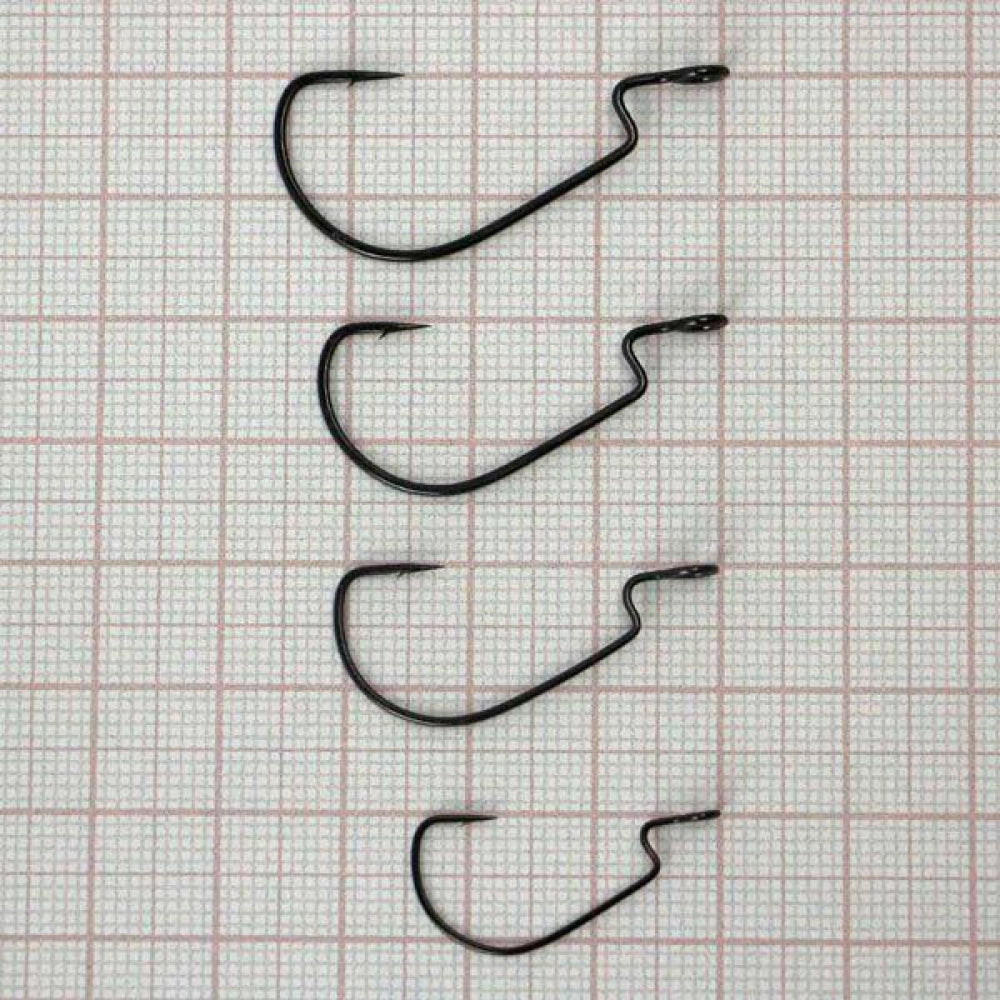 Set of five black fishing hooks on a grid background