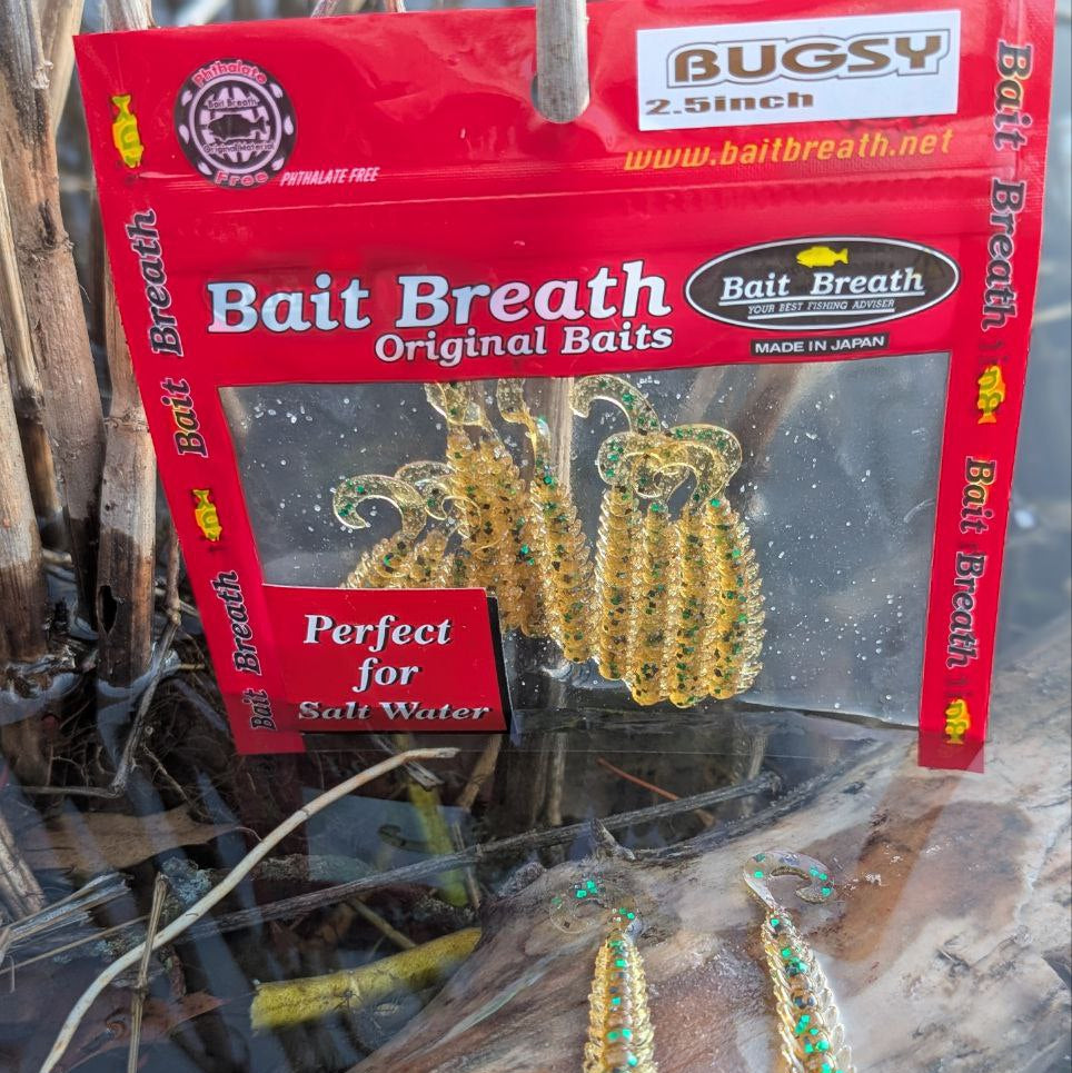 Bait Breath Bugsy 2.5-inch creature baits displayed beside their red retail package on a log.