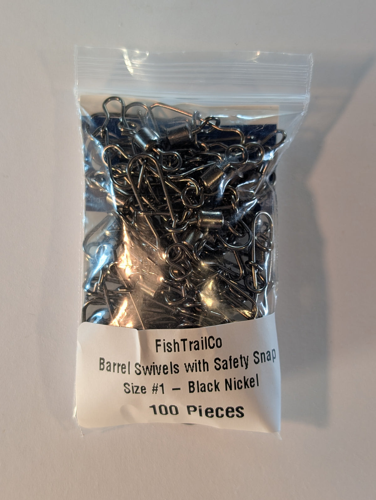 FishTrailCo size #1 black nickel barrel swivels with safety snaps, 100-piece package.