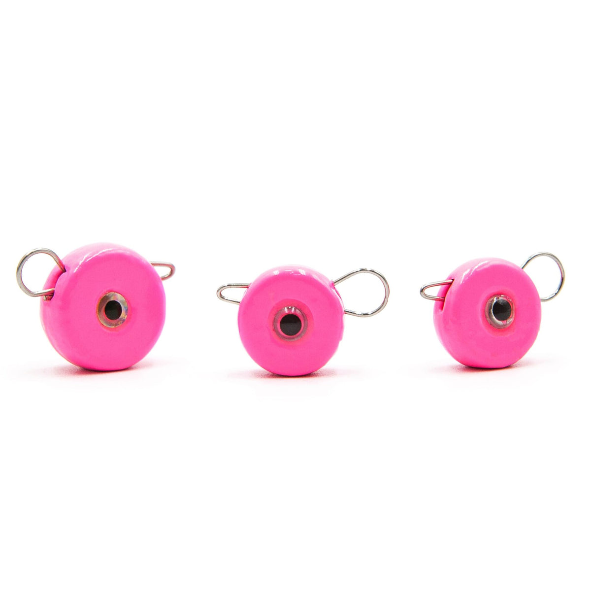 Three pink FishTrailCo Eccentric quick-change jig weights with removable wire clips.