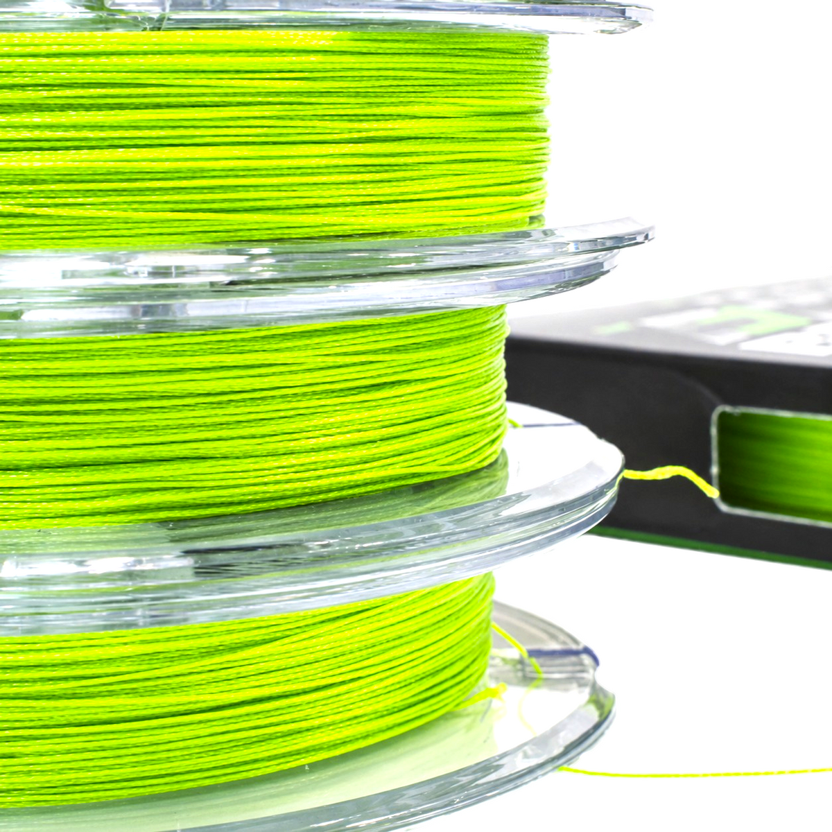 Close-up of green Intech First Braid X8 braided fishing line wound on three stacked clear spools.